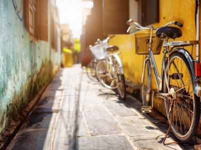 Bicycles-parked-near-yellow-wall